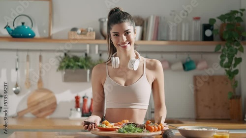 Video of fitness woman making a healthy poke bowl in the kitchen at home. photo