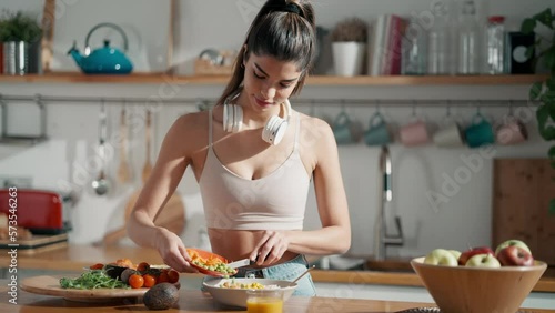 Video of fitness woman making a healthy poke bowl in the kitchen at home.