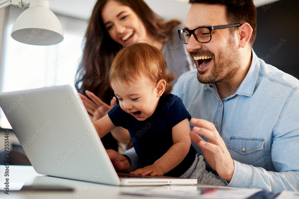 Young parents mom, dad and their toddler son have a video call via laptop at home Young parents mom, dad and their toddler son have a video call via laptop at home