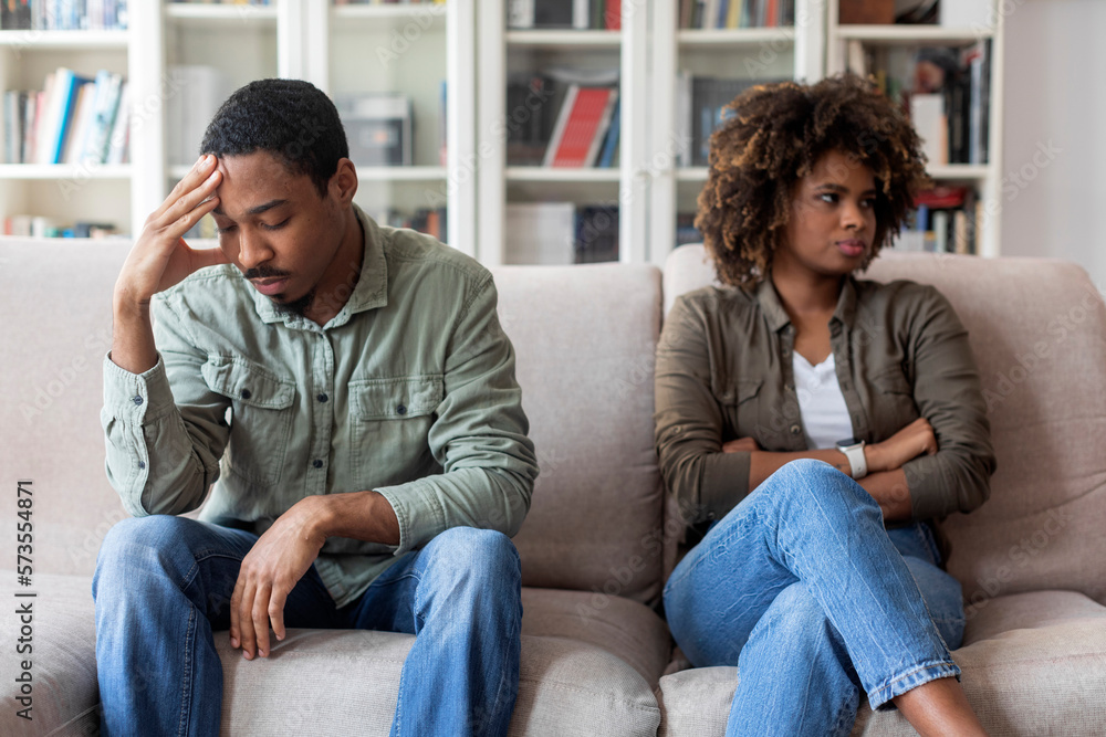 Unhappy black couple sittng on sofa at therapist office Unhappy black couple sittng on sofa at therapist office