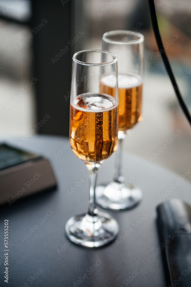 Two glasses of champagne stand on the table at the wedding ceremony