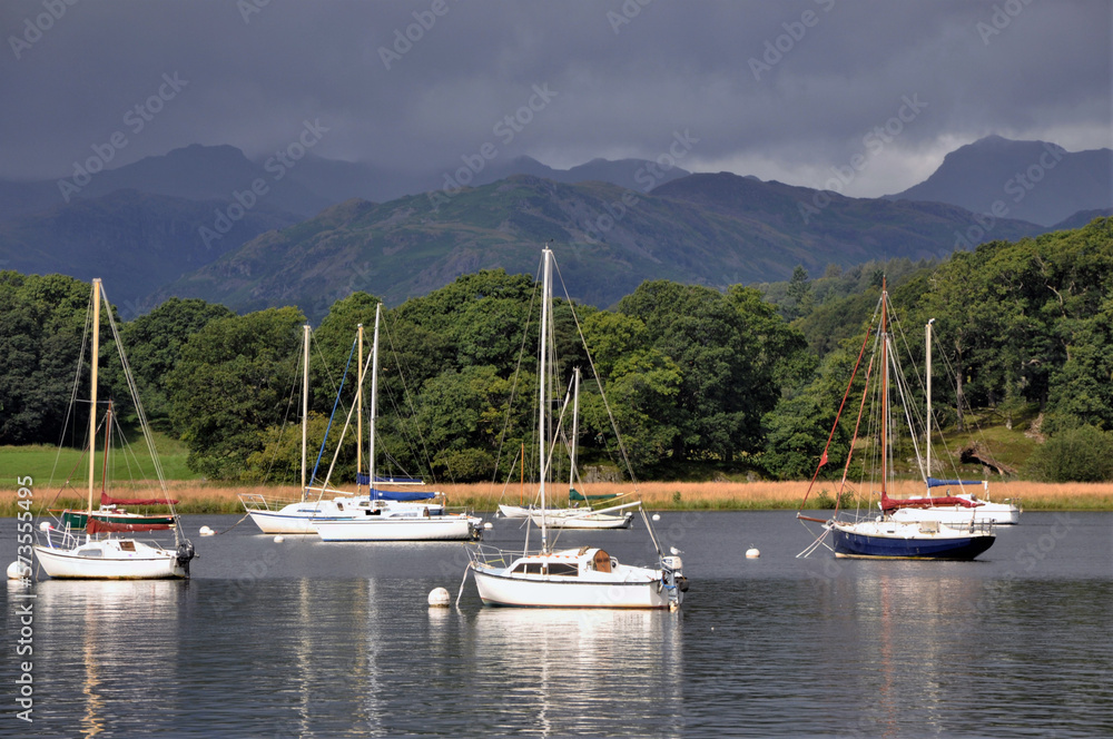 Boats tied up on Lake Coniston in the Lake District with a summer storm brewing