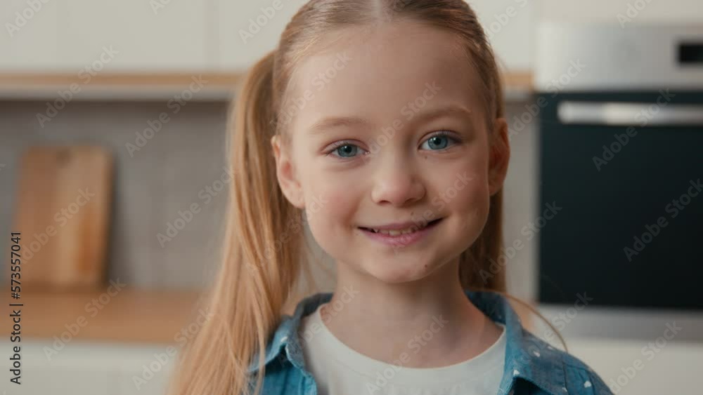 Close up portrait Caucasian funny little girl smiling looking at camera ...