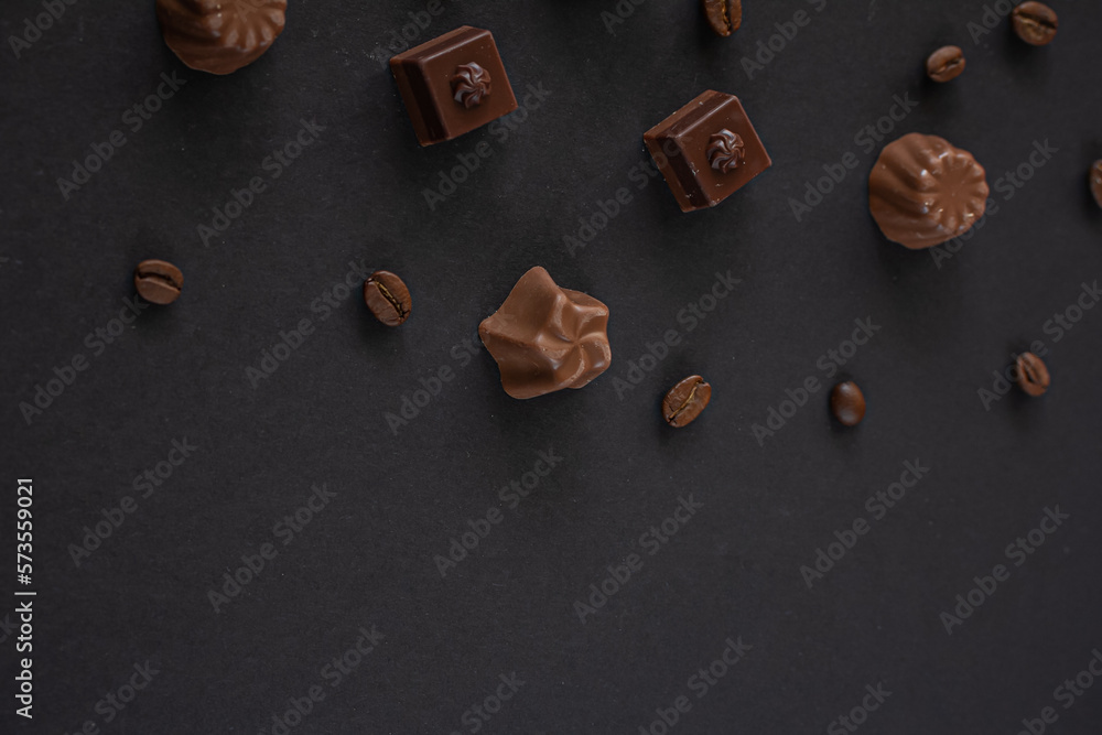 Assorted Chocolates and coffee beans on dark background , top view, copy space Assorted Chocolates and coffee beans on dark background , top view, copy space