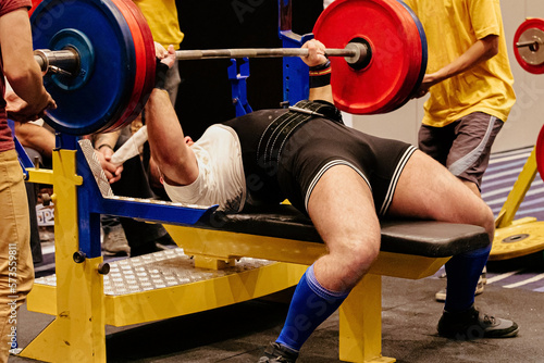 man athlete bench press exercise in powerlifting competition photo