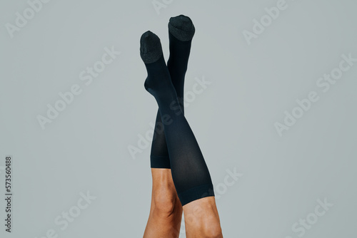 Bild auf Leinwand man upside down wearing compression socks