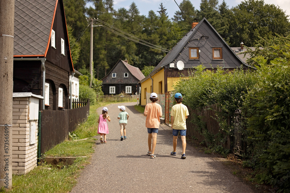 Child, walking in a small village in Czech Republic on a sunny day