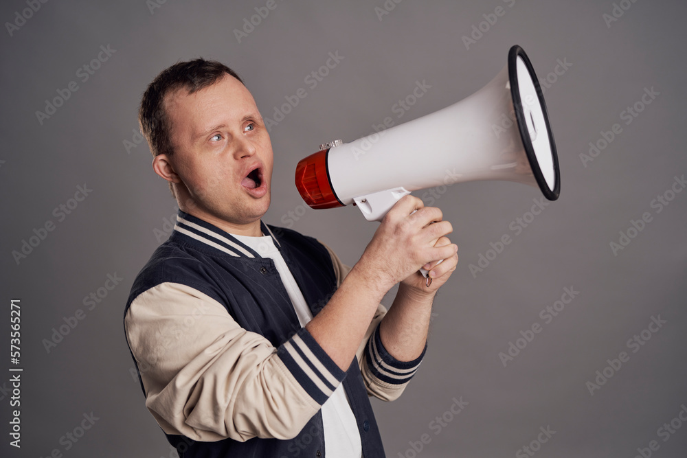 Man with down syndrome speaking through a white megaphone Man with down syndrome speaking through a white megaphone