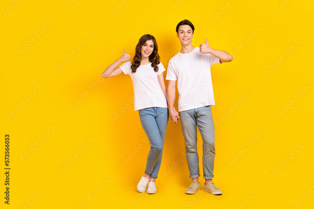 Full length photo of sweet confident husband wife dressed white t-shirts showing thumbs up empty space isolated yellow color background