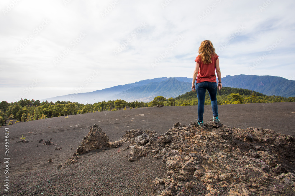 Fototapeta premium Young woman and sunset in Llano del Jable, La Palma, Canary islands.