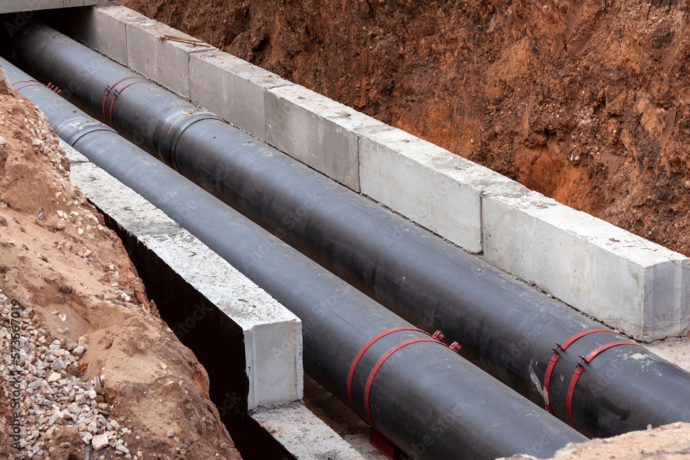 Insulated pipes in the trench. Water main reconstruction and replacement. Insulated pipes in the trench. Water main reconstruction and replacement.