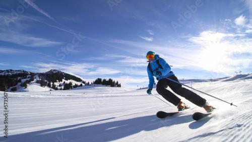 professional skier skiing on slopes in the Swiss alps towards the camera photo