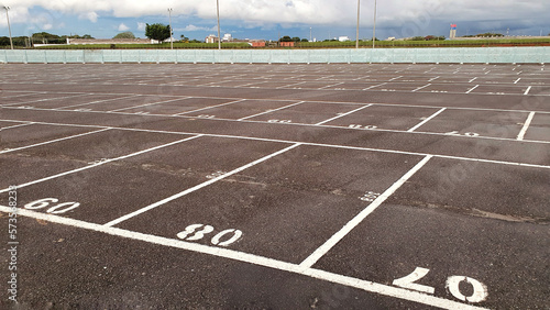 Empty parking lot - numbered parking spaces in drive-in photo