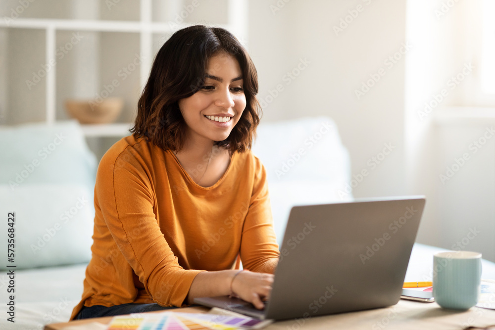 Remote Work Concept. Happy Young Arab Woman Working On Laptop At Home Remote Work Concept. Happy Young Arab Woman Working On Laptop At Home