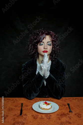 Pretty young girl with cherry fancy cake photo