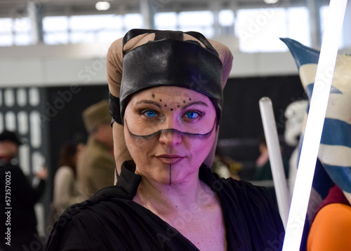 Warrior woman with purple sword in cosplay event