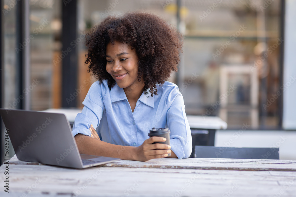Young happy professional business woman worker employee sitting at desk working on laptop in corporate outside. Smiling female student using computer technology learning online, doing web research. Young happy professional business woman worker employee sitting at desk working on laptop in corporate outside. Smiling female student using computer technology learning online, doing web research.