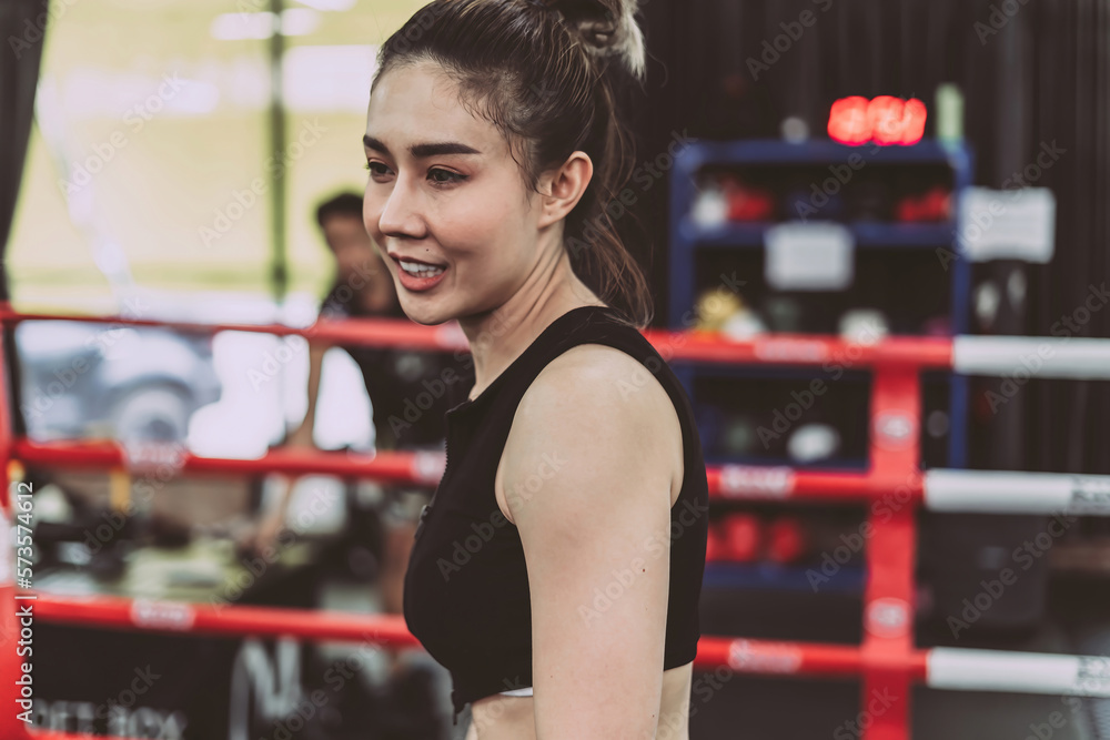 boxing confident woman wearing punching gloves. strong determined female athlete with boxing gloves doing arms guard pose on gym ring. confident boxer training for health and build muscle for body boxing confident woman wearing punching gloves. strong determined female athlete with boxing gloves doing arms guard pose on gym ring. confident boxer training for health and build muscle for body