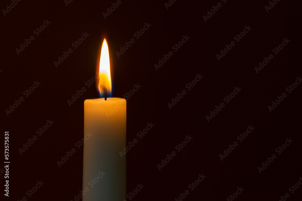 Candle flame on a dark background, symbol of prayer and remembrance.Religion concept.Closeup.Copy space. Candle flame on a dark background, symbol of prayer and remembrance.Religion concept.Closeup.Copy space.