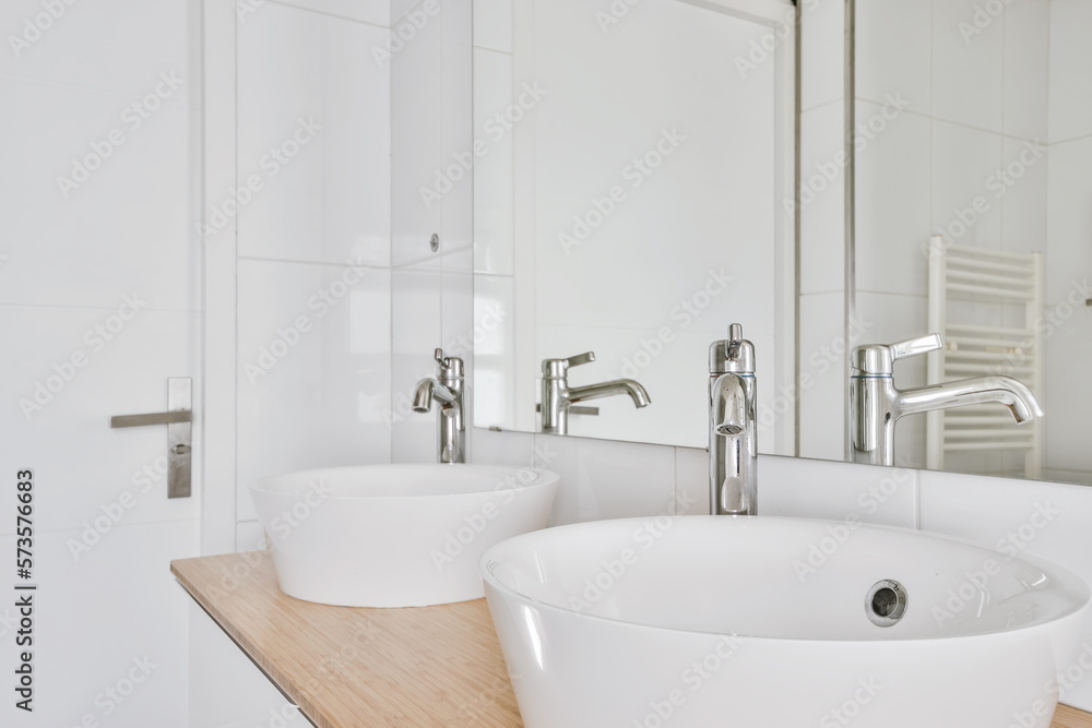 Interior of modern bathroom with white tiled walls Interior of modern bathroom with white tiled walls