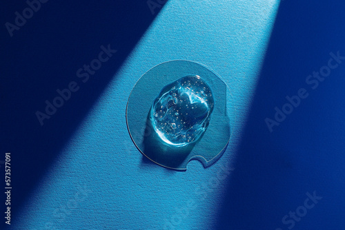 Transparent facial gel on glass surface photo