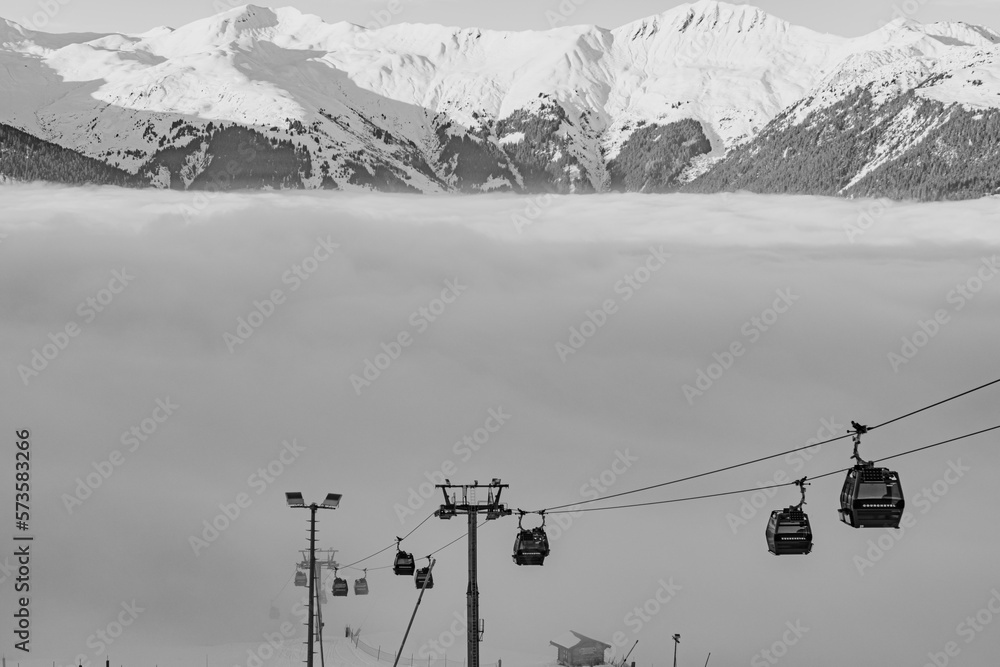 Ski lift in the Alps with clouds coming in Ski lift in the Alps with clouds coming in