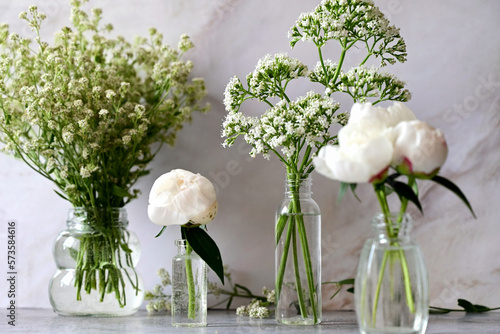 Fresh white gypsophila, piones on a white background. Wedding date. An invitation to a holiday. Congratulation.An empty space for text. View from above.