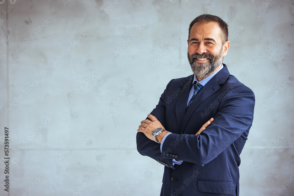 Portrait of a confident mature businessman working in a modern office. Mature cheerful executive businessman at workspace office. Portrait of smiling ceo at modern office workplace in suit - obrazy, fototapety, plakaty 