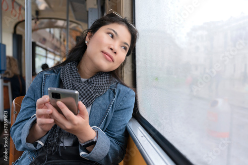 Free Download Asian traveller female woman riding bus sight seeing urban vienna capital city tour of Hungary she is prefer to see lifestyle of people in town,Young Asian woman in the bus with rainy day. - GFXLoad