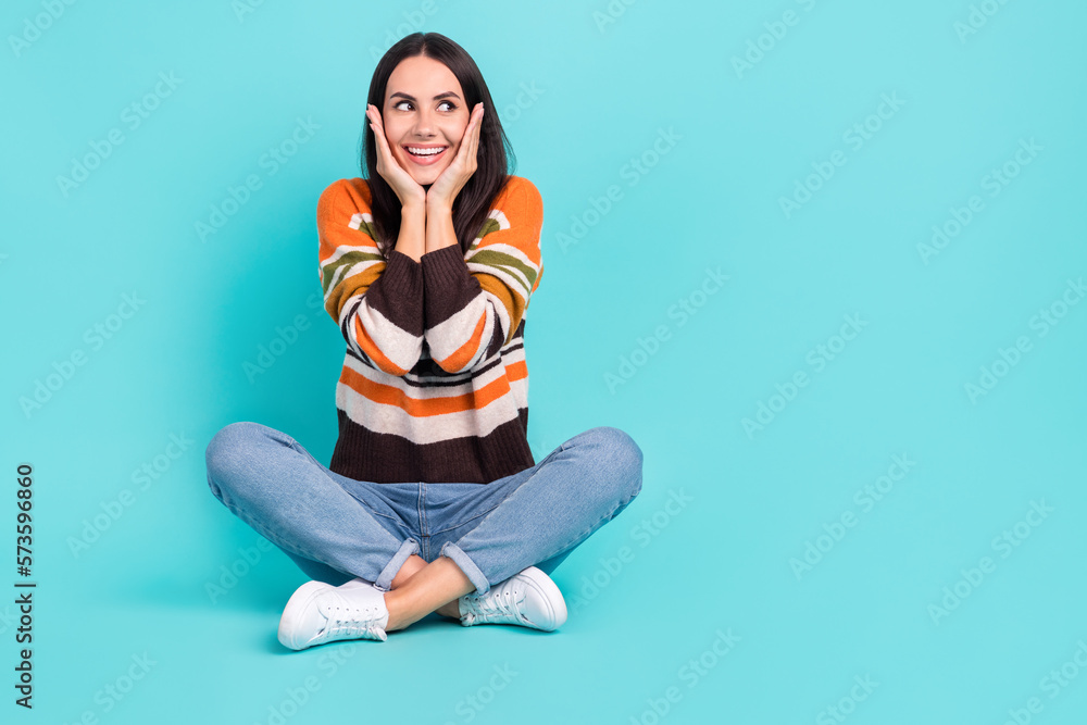 Full length photo of adorable excited woman wear striped sweater arms cheeks empty space isolated turquoise color background Full length photo of adorable excited woman wear striped sweater arms cheeks empty space isolated turquoise color background