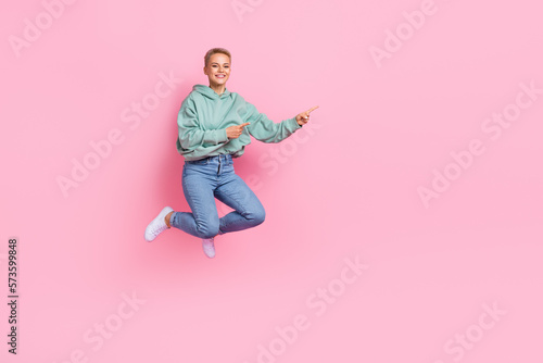Full length photo of glad lovely lady wear trendy outfit two arm presenting empty space positive feedback isolated on pink color background