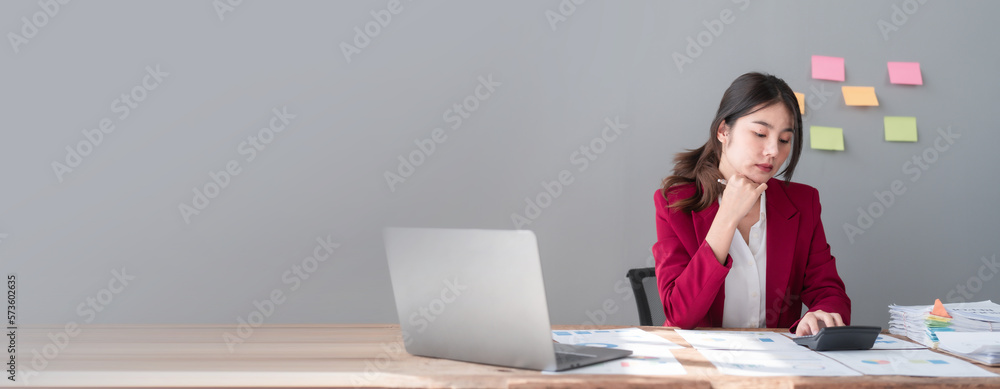 © M+Isolation+Photo - Hard working of asian people bookkeepers working with balance sheet and taxation, company quarterly reports of accounting and marketing. Using calculator