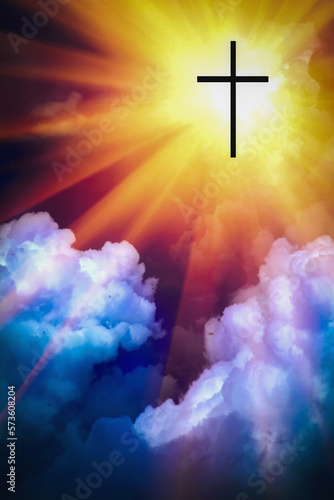 Silhouette of Christian cross against blue sky background. Vertical image.