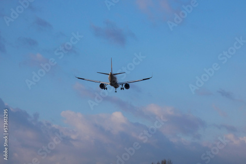 Commercial aircraft overflying the sky and arriving at airport