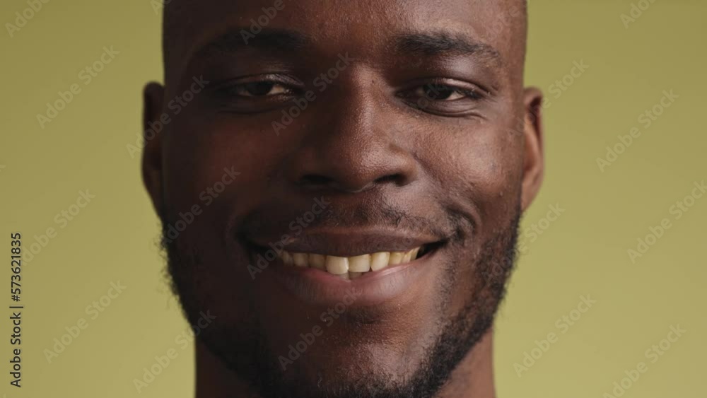 Young black man looks at the camera and smiles Young black man looks at the camera and smiles
