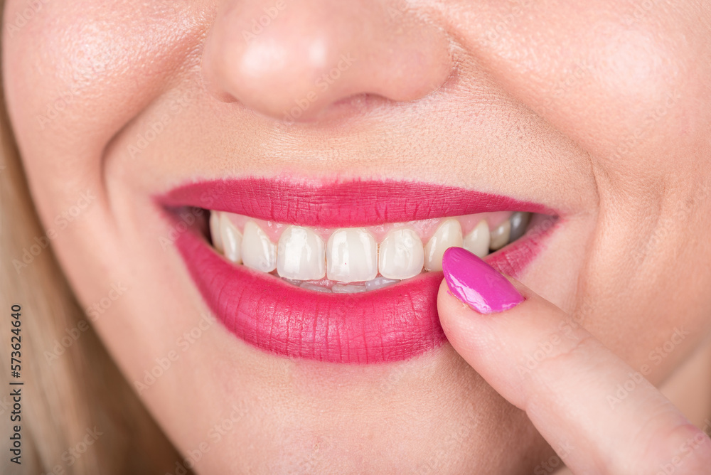Naklejka premium Happy Smile Woman Face with Open Mouth and Red Lipstick and Polish Nail on Lip. Curious. Studio Photo Shoot.