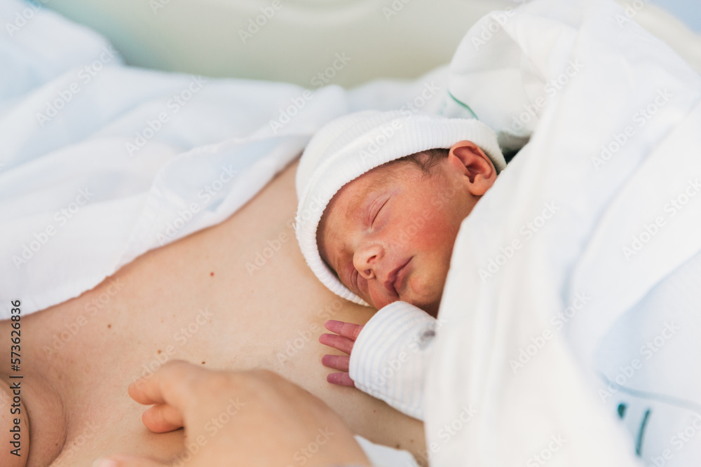 Close-up of a newborn baby sleeping on his mother. Close-up of a newborn baby sleeping on his mother.