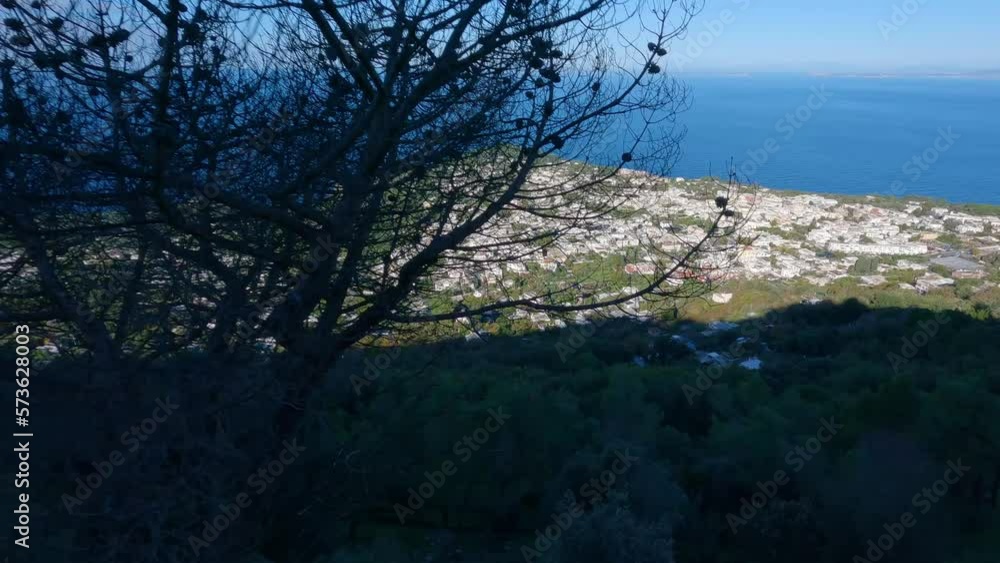 Touristic Town on Capri Island, Bay of Naples, Italy. Sunny Blue Sky. Nature Background. View from top of Mountain. Slow Motion Cinematic Touristic Town on Capri Island, Bay of Naples, Italy. Sunny Blue Sky. Nature Background. View from top of Mountain. Slow Motion Cinematic