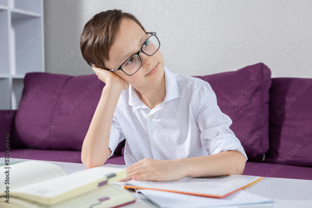 Young boy reading book at home.
Education, childhood, homework and school concept. Young boy reading book at home.
Education, childhood, homework and school concept.
