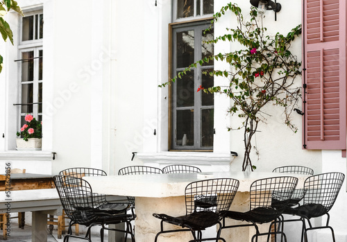 Beautiful bright summer cafe with iron chairs on the street of Cyprus. Selective focus