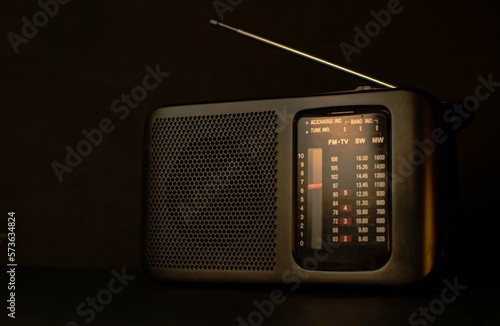 An old model radio on a black background. Selective focus, low key. 