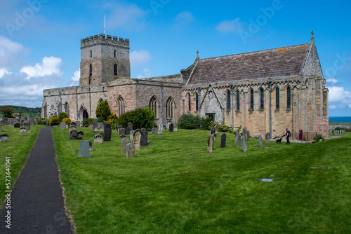 The exterior of St Aidan's Church and churchyard in Bamburgh, Northumberland, UK