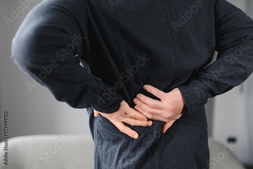 Senior man is suffering from pain in lower back at home