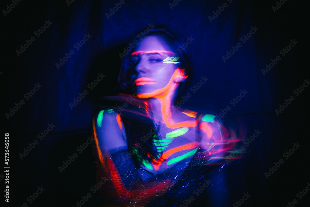 Portrait of a beautiful woman with blue sequins on her face. Girl with artistic make-up in Light color. Fashion model with colorful makeup. Portrait of a beautiful woman with blue sequins on her face. Girl with artistic make-up in Light color. Fashion model with colorful makeup.