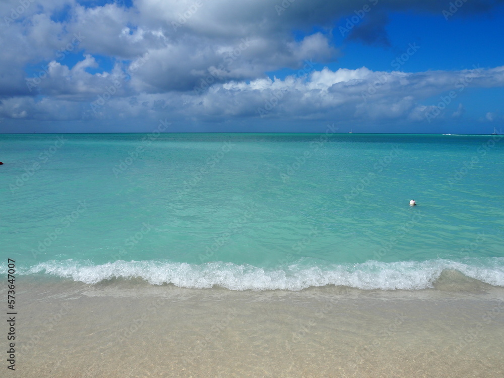 Caribbean ocean and sand. beautiful turquoise water with blue sky Caribbean ocean and sand. beautiful turquoise water with blue sky