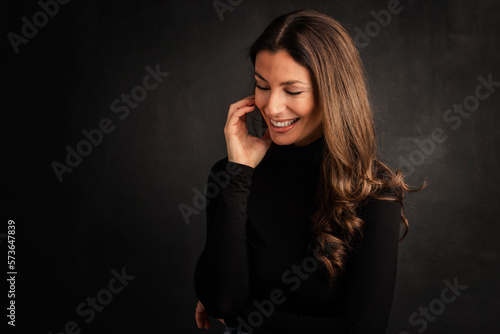 Attractive brunette haired woman studio portrait against at isolated background © gzorgz