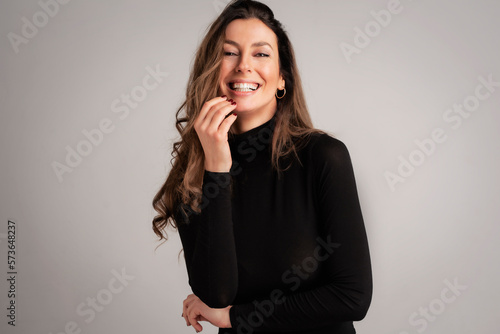 Obraz na plátně Studio portrait of attractive brunette haired woman posing at isolated backgroun