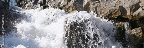 River flowing through rocks and stones closeup