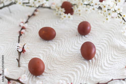 Easter background with colored eggs, colored easter eggs and blooming branches. Easter composition.