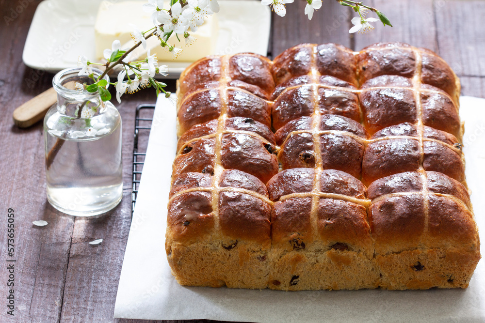 Cross buns served with butter, honey and tea. Easter breakfast.